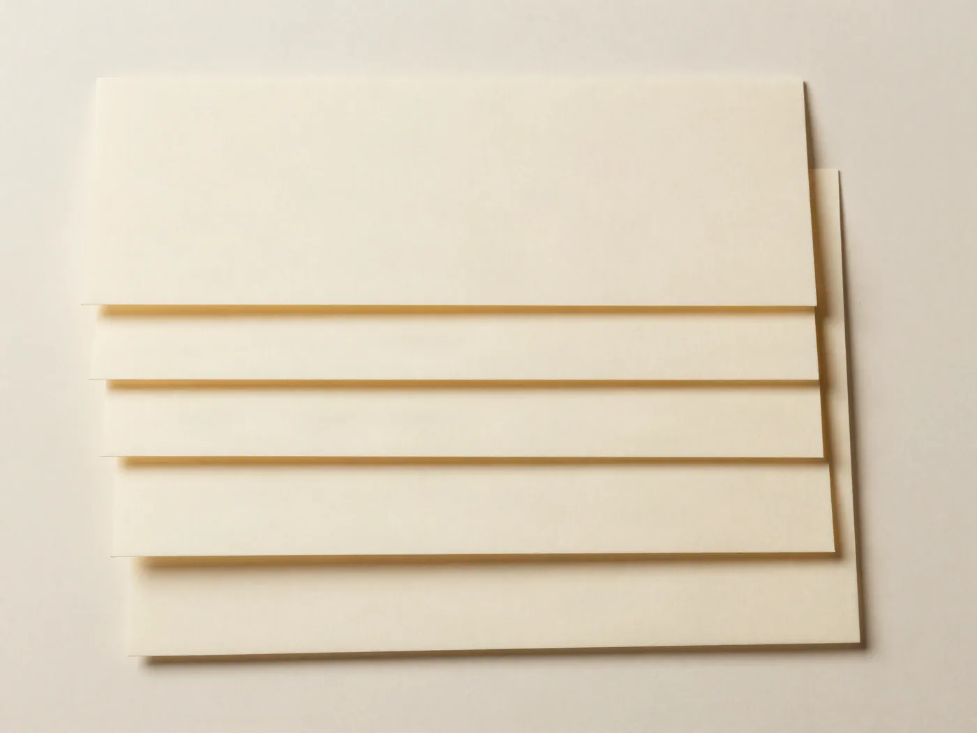 Cream paper sheets arranged in an offset stepped cascade.